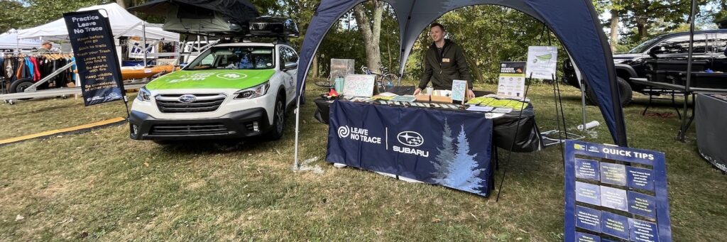 A Subaru/Leave No Trace traveling education team set up at a tradeshow.